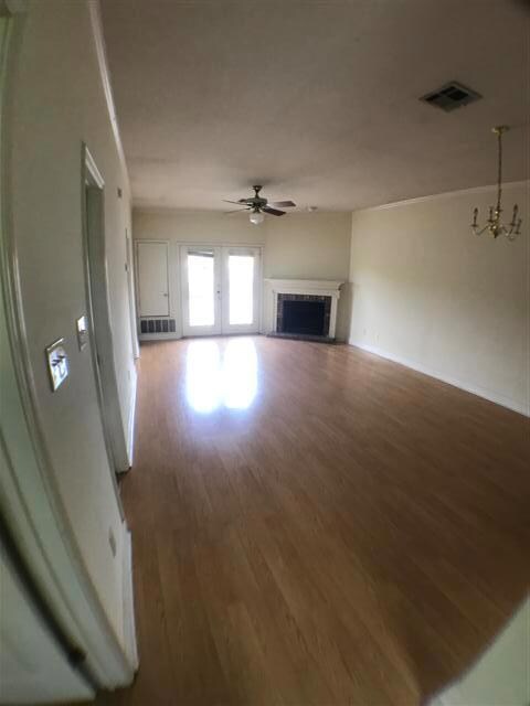 Unfurnished living room featuring a ceiling fan, 