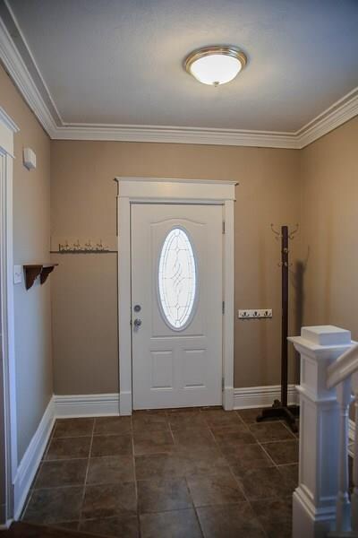 Large entry hall with crown molding.  New front do