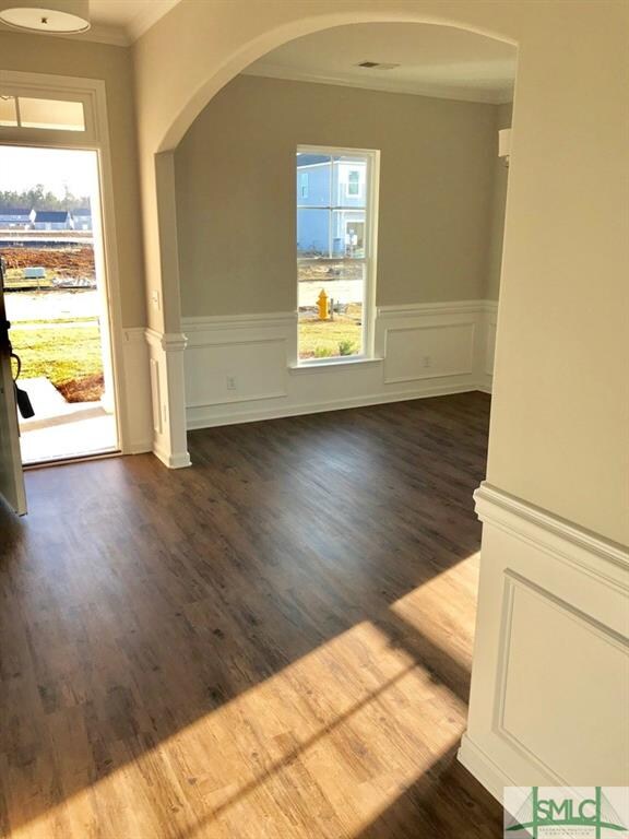 Arch over dining room entry. Crown molding & chair