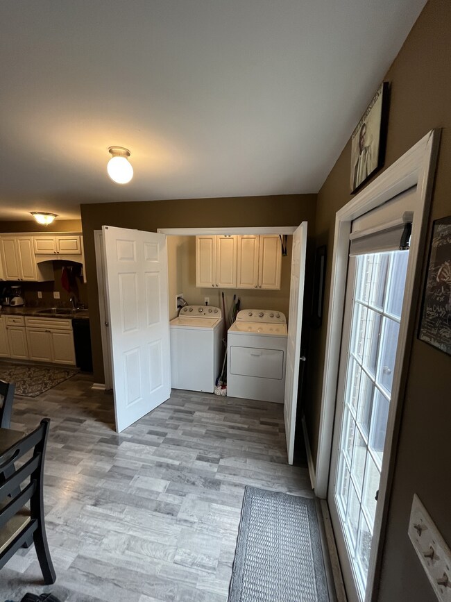 Laundry with cabinets.