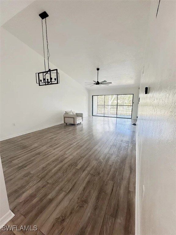 Unfurnished living room with dark wood-type floori