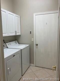 INSIDE UTILITY ROOM,  WASHER, DRYER, WITH CABINETS. TILE FLOORS GOES INSIDE TO GARAGE AREA.