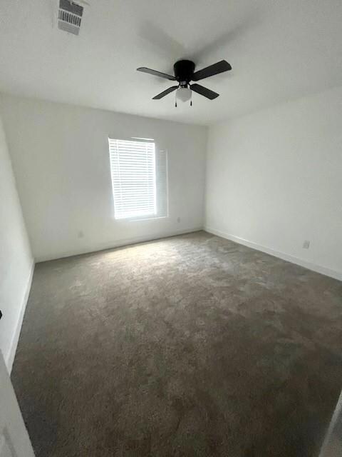 Unfurnished room featuring carpet flooring and ceiling fan