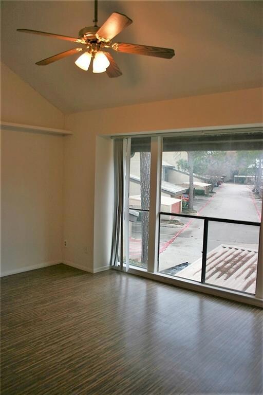 Bedroom with wall of windows and laminate wood loo