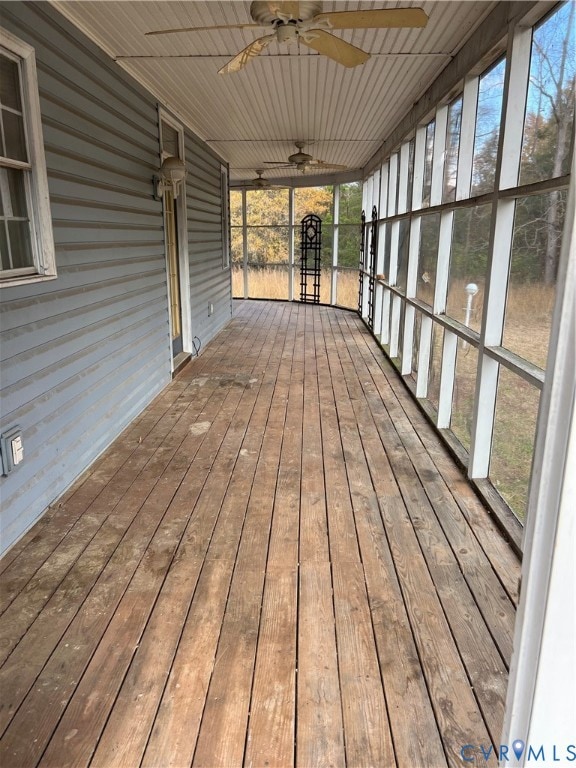 Wrap around screen porch featuring a ceiling fan