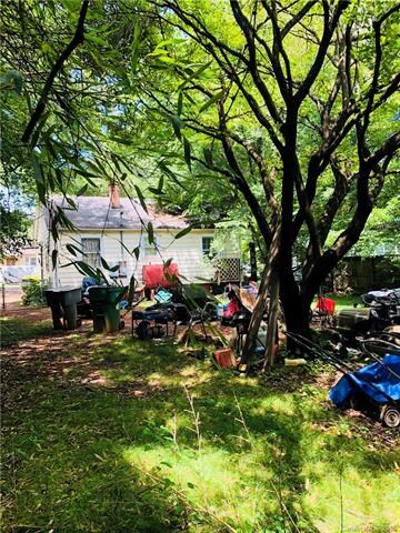 Back yard with mature trees and full fencing.