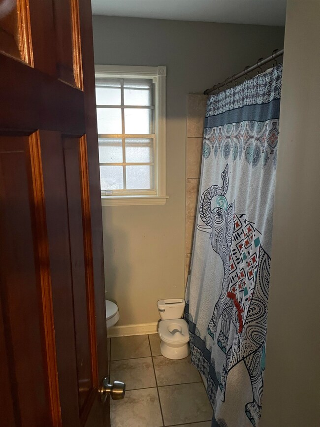 Bathroom with tile patterned floors and toilet