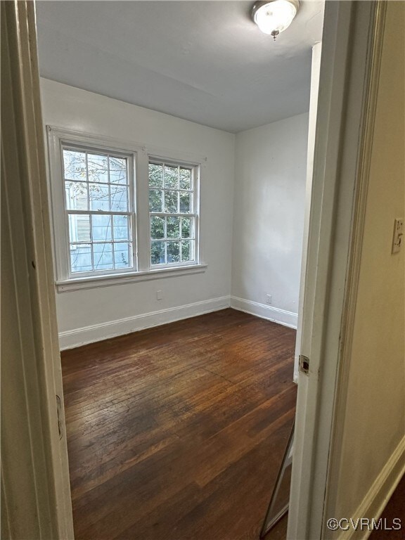 Spare room featuring dark hardwood / wood-style fl