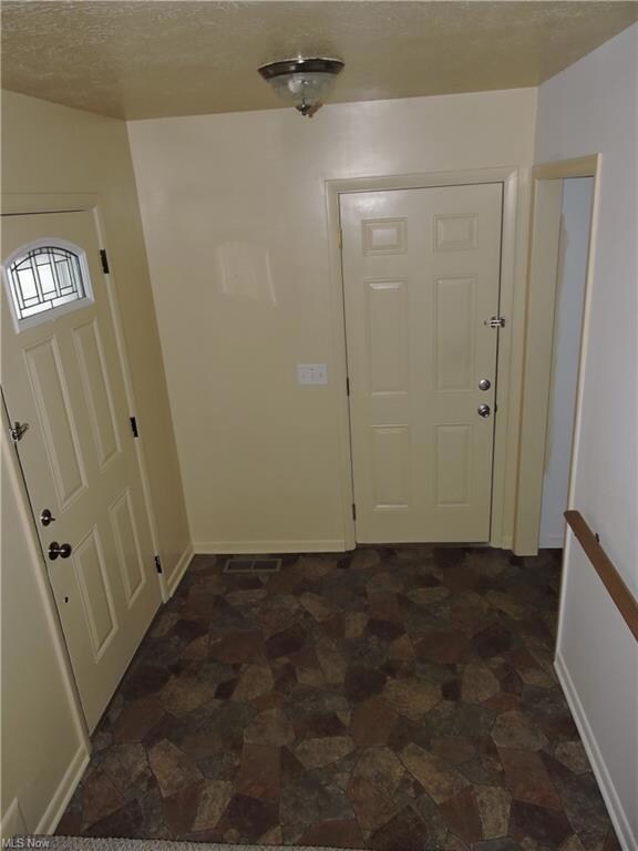 Main floor foyer, Front door, garage entry and Lau