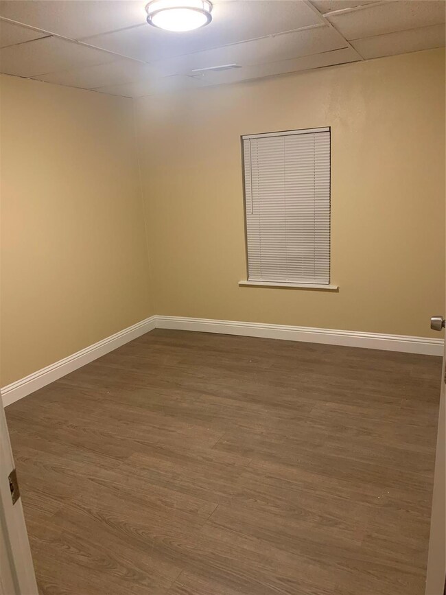 Unfurnished room with dark hardwood / wood-style f