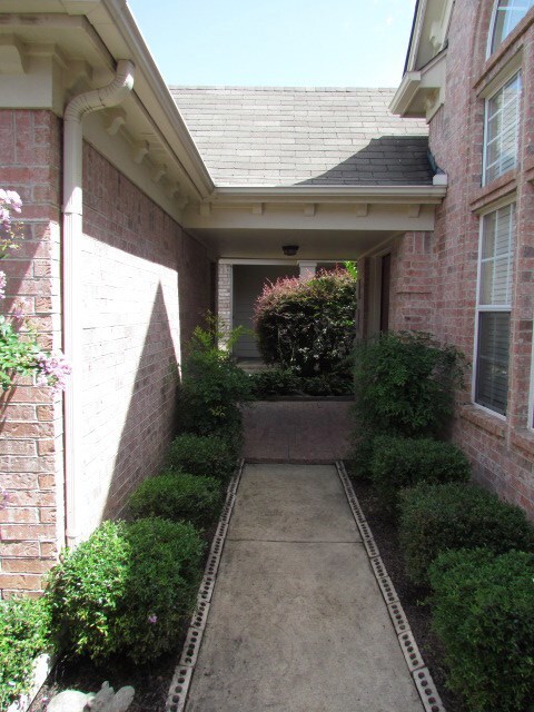 View of covered breezeway from garage to main entr