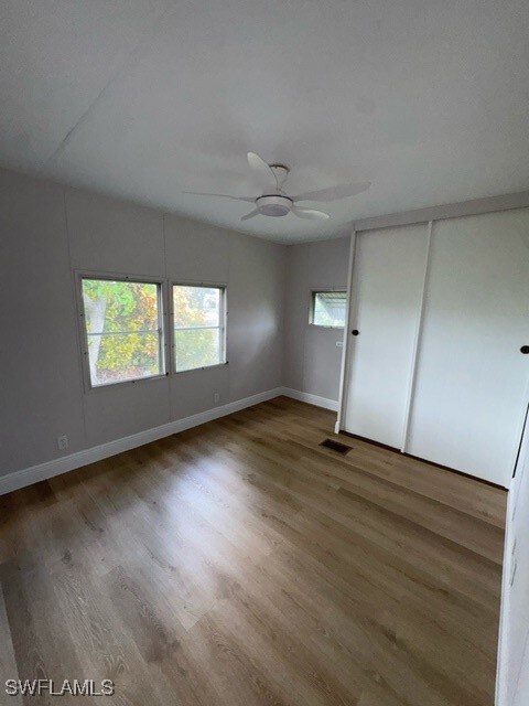 Unfurnished bedroom with wood finished floors, cei