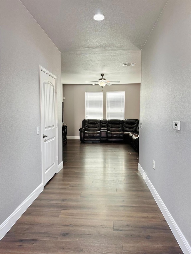 Unfurnished living room featuring baseboards, vis