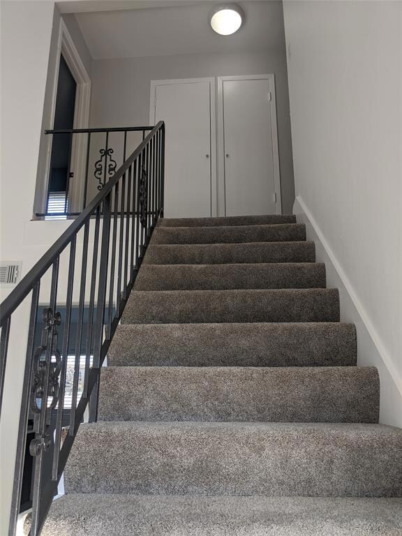 Stairway to upstairs bedrooms and bathroom.