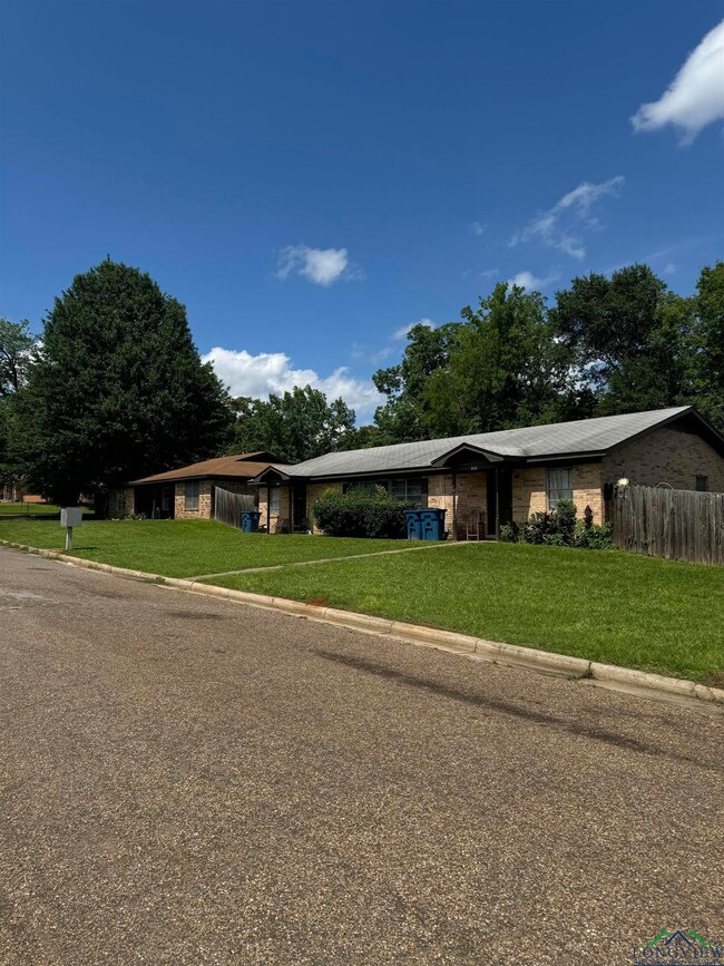 Single story home with a front lawn