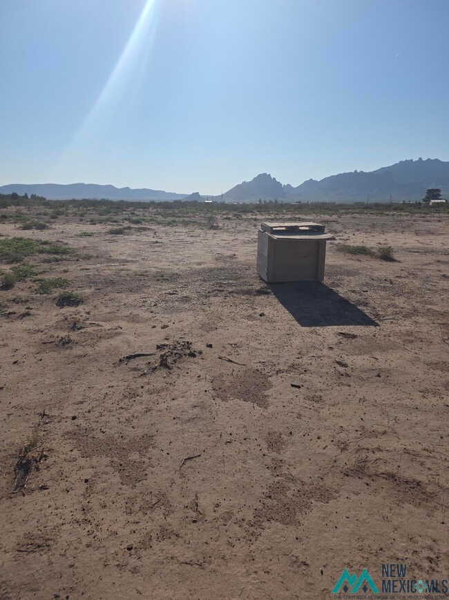 View of mountain backdrop with a desert landscape and rural landscape