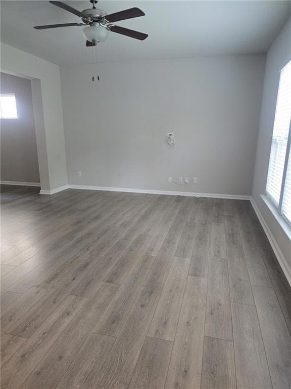 Empty room featuring light wood-style flooring and a ceiling fan