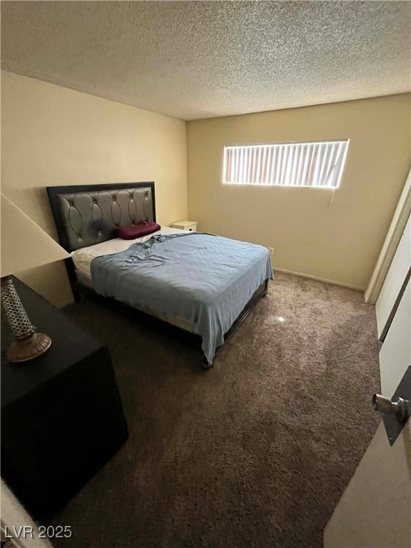 Carpeted bedroom with a textured ceiling