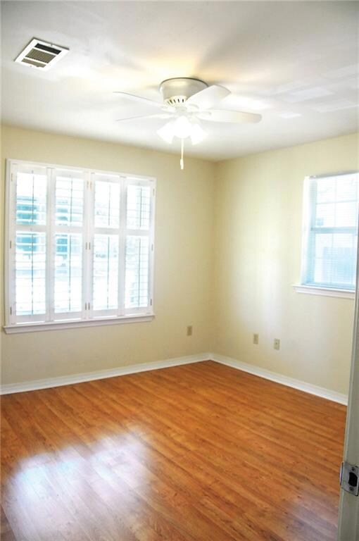 Front bedroom with double closets, plantation shutters  and wood lam floors. Steps to full bathroom in pristine condition!