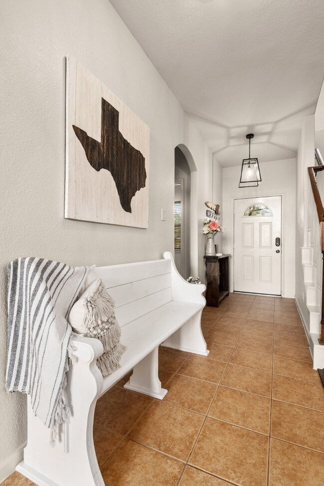 Charming entry way. To the left is a half bath, laundry room and the garage.
