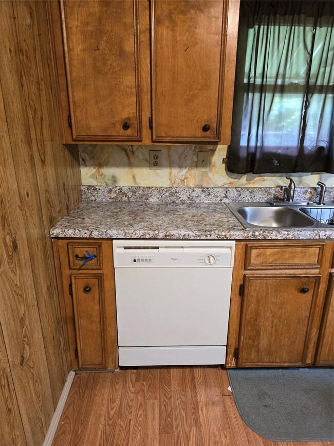 Kitchen with sink, dishwasher, and hardwood / wood
