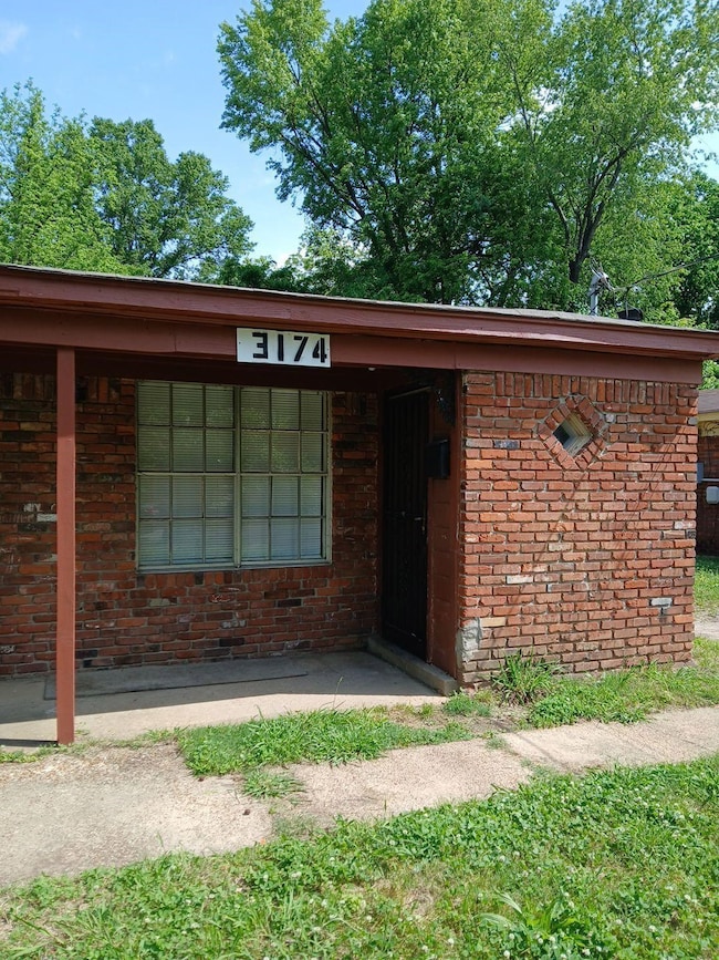 Doorway to property with brick siding