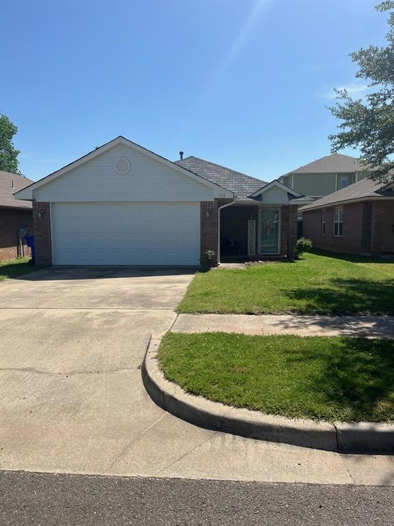 Ranch-style house with brick siding, a front yard, concrete driveway, and a garage