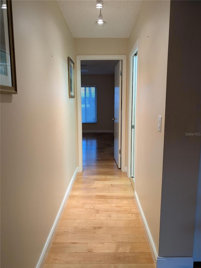 Guest Bedroom view down hallway into Primary ensuite.  Guest bath on right.