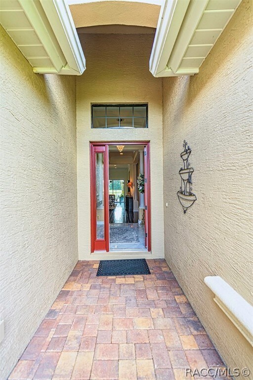 Long pavered exterior entry.