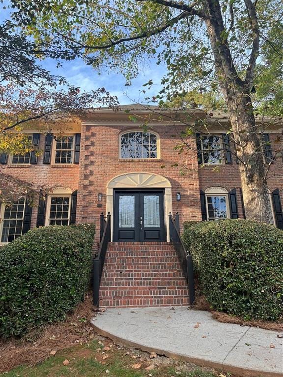 Colonial inspired home featuring french doors and brick siding.  All exterior trim newly painted.  New roof