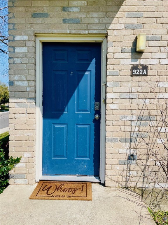 View of exterior entry featuring brick siding