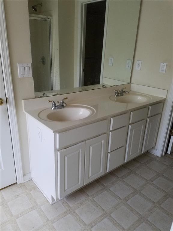 Full bathroom with double vanity and a stall shower