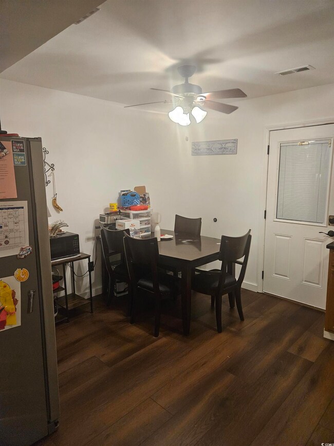 Dining room with dark hardwood / wood-style floors