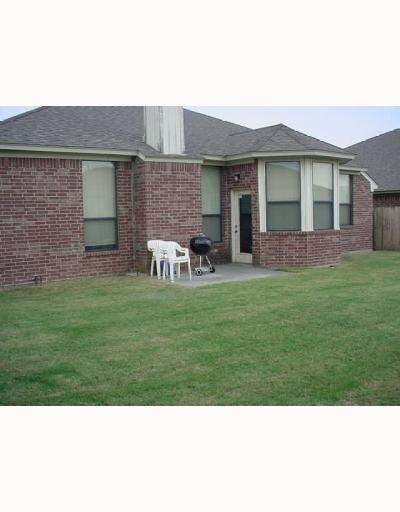 Exterior Back. Well groomed backyard with open pat