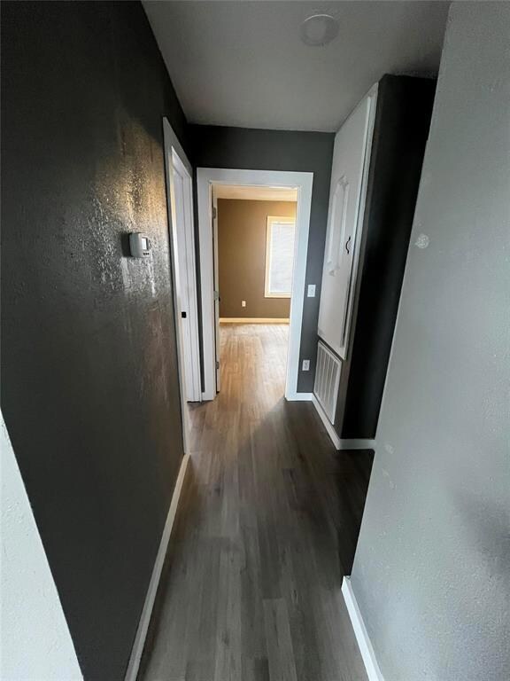 Hall with light hardwood / wood-style flooring