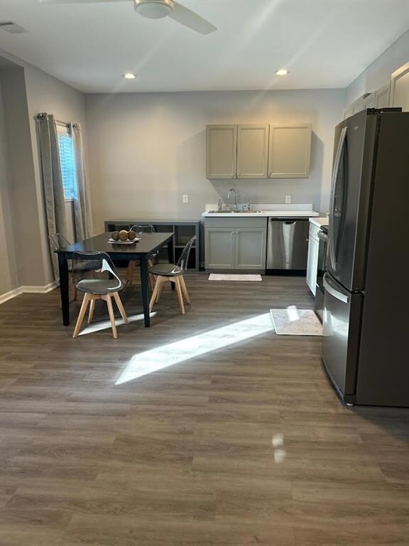 Kitchen featuring dark wood-style floors, stainles