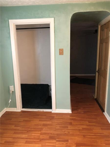 View of the bedroom facing the door and closet.  T