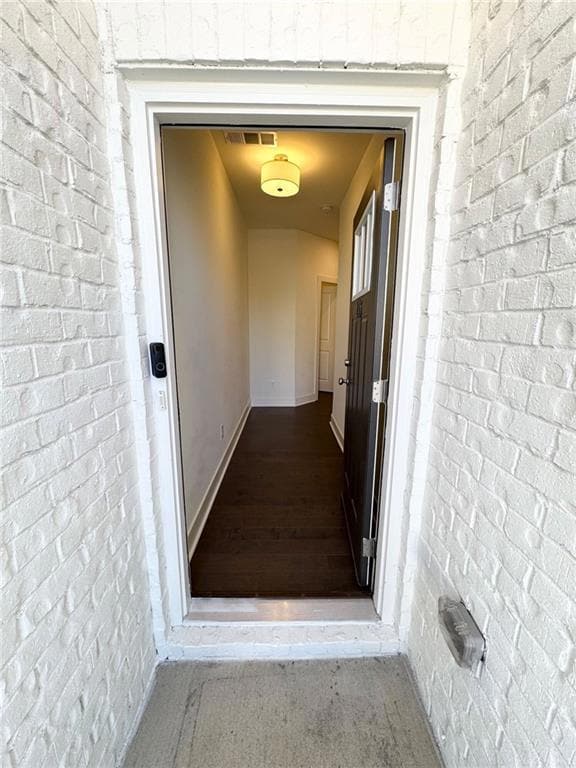 Entrance to property featuring brick siding
