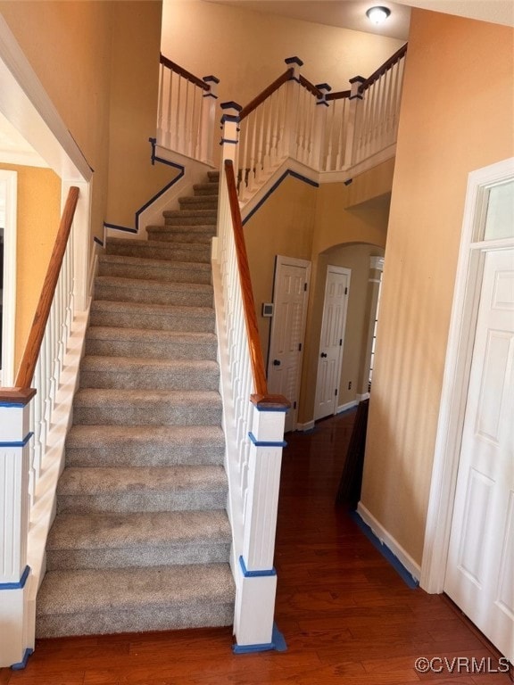 Stairs with arched walkways, wood finished floors,