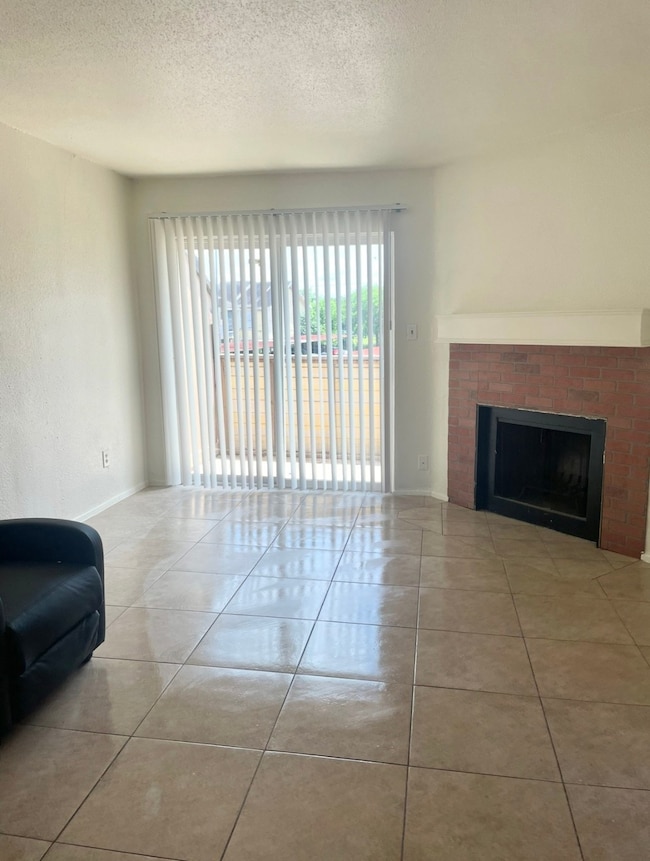 Living area with chimney and balcony view