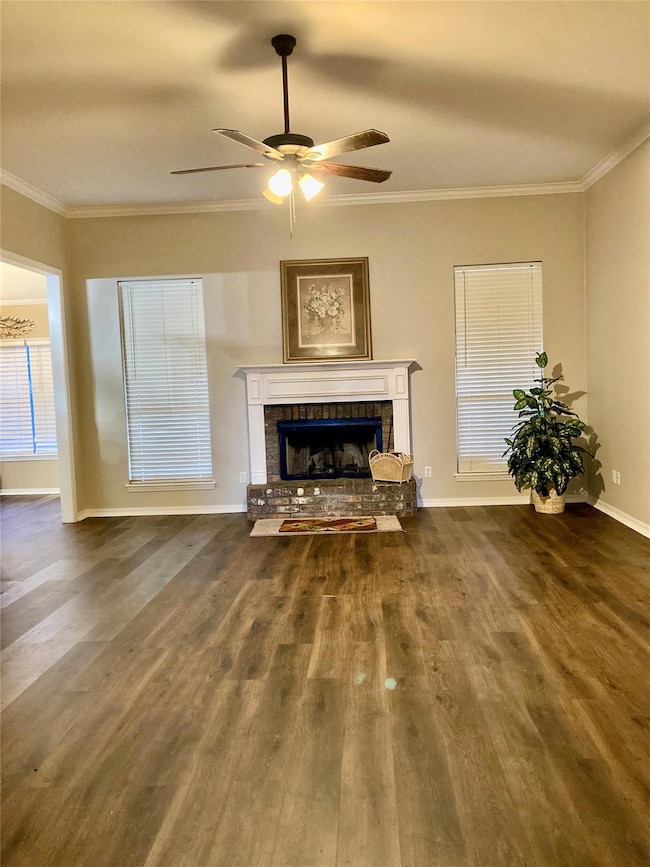 Unfurnished living room featuring crown molding, d
