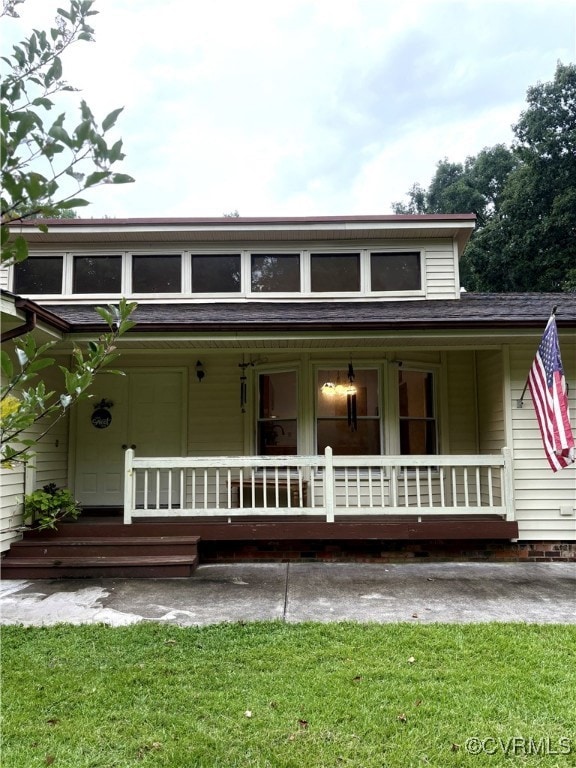 Farmhouse inspired home featuring a porch, roof wi
