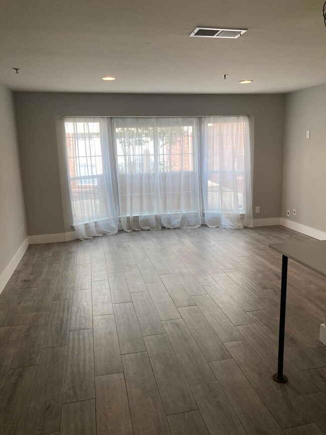 A large living room view from the kitchen to the b