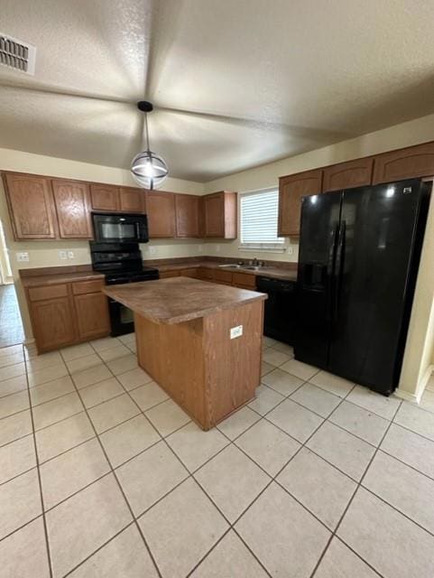 Kitchen featuring black appliances, a center isla