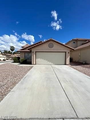 View of front of house featuring a garage, concret