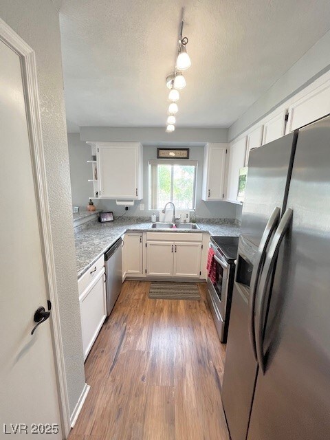 Kitchen featuring stainless steel appliances, wood