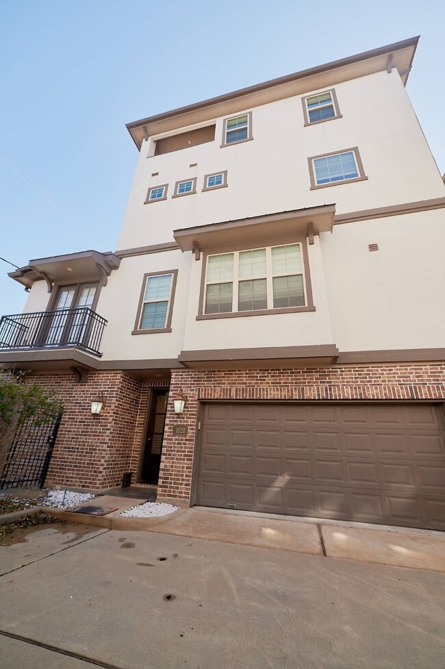 Brick and Stucco 4-story home.