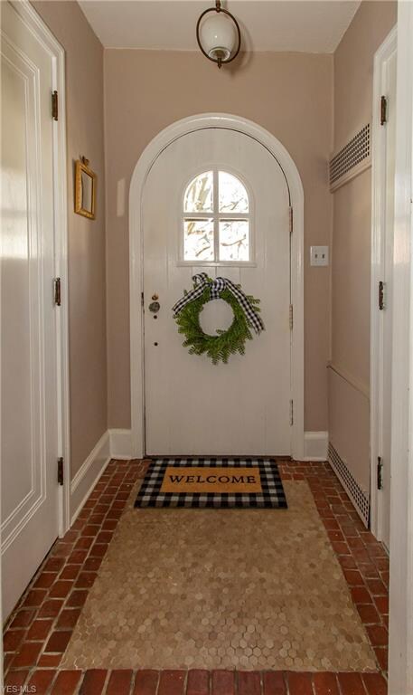 The entry foyer is full of charm with arched doorw
