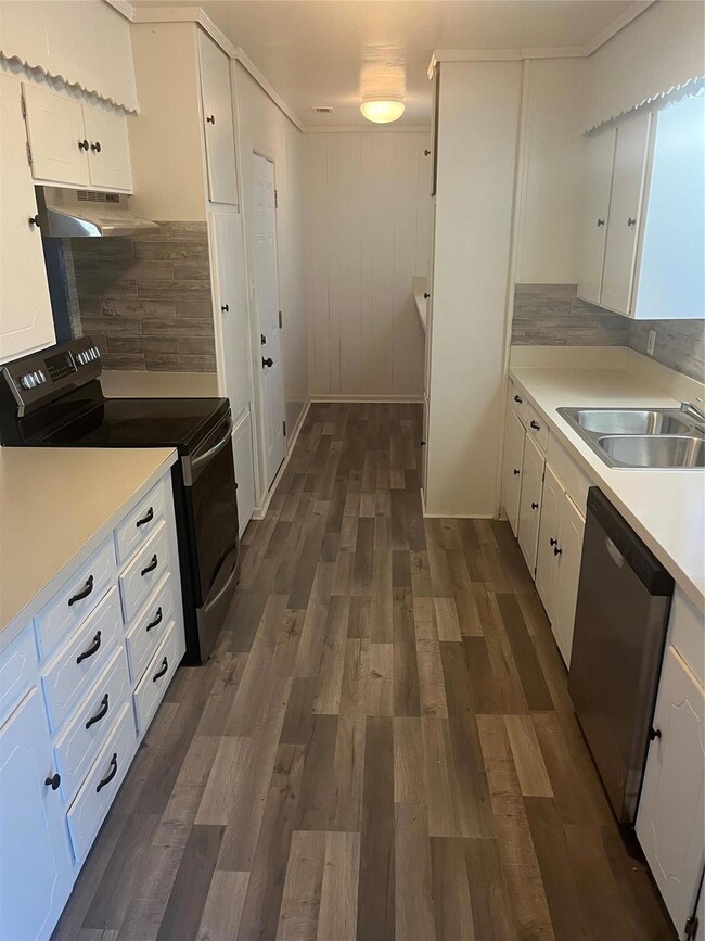 Kitchen with wood-style floors, attractive backspl