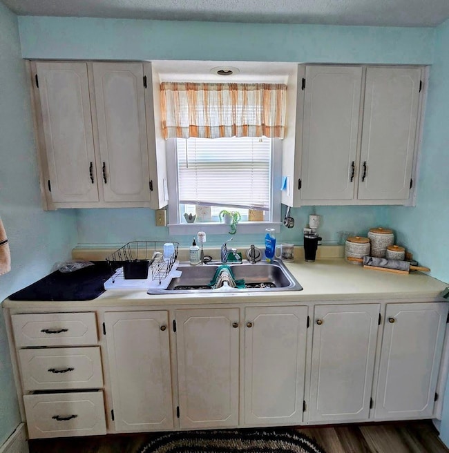 Attractive white cabinets give kitchen plenty of light